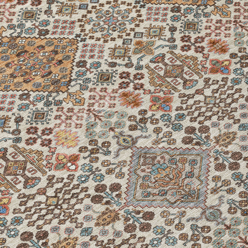 Beige geometric rug close-up with teal, copper, and rust medallion patterns