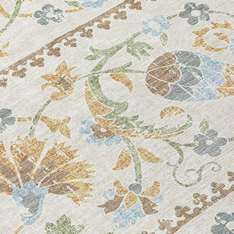 Close-up of ivory area rug with floral medallion details in blue, green, and gold