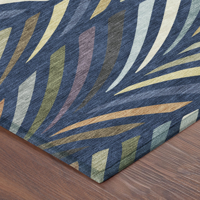 Navy blue abstract area rug with gold and cream striped leaf pattern corner