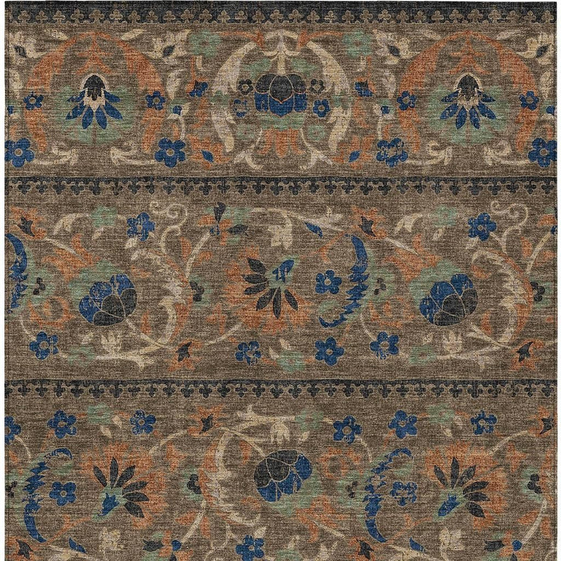 Floral patterned area rug with blue and orange accents on chocolate brown ground