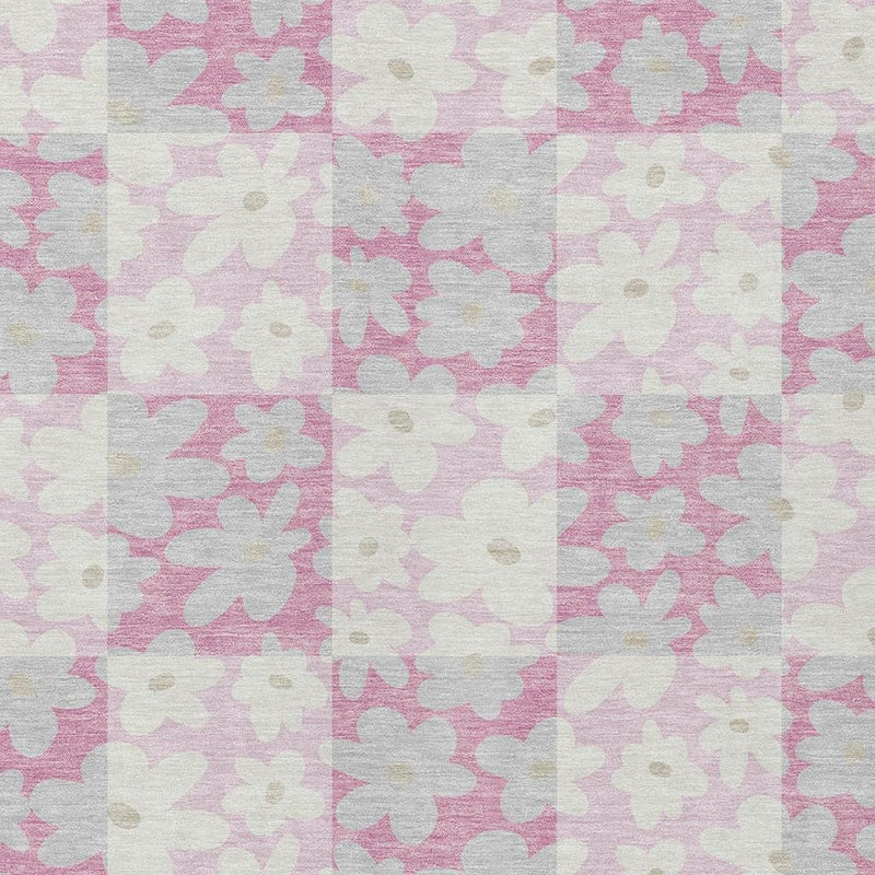 Close-up of washable area rug with pink and gray floral pattern on pale base