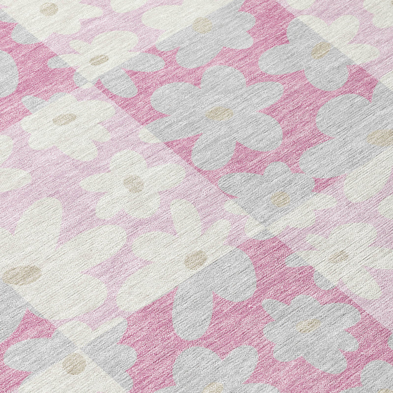 Rug surface close-up with pink and gray floral silhouettes on light background