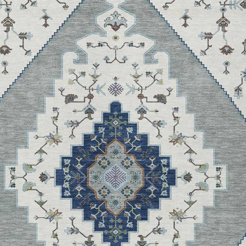 Geometric area rug pattern detail with floral medallion in blue and ivory