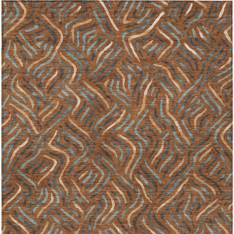 Close view of orange and teal abstract area rug with swirling wavy lines