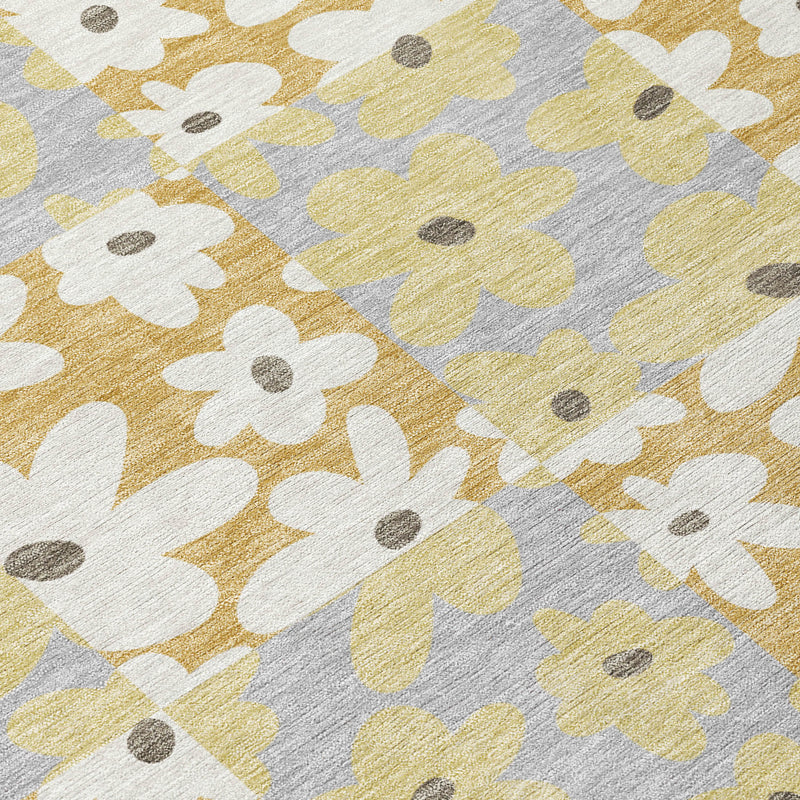 Close-up floral patchwork pattern on gray area rug with gold and ivory flowers