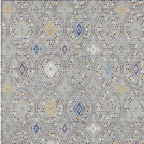 Geometric area rug with light gray base and blue, yellow, purple diamond motifs