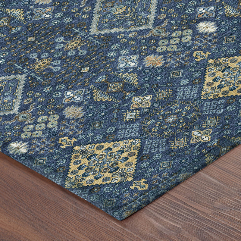 Corner of navy blue and gold geometric area rug with diamond pattern