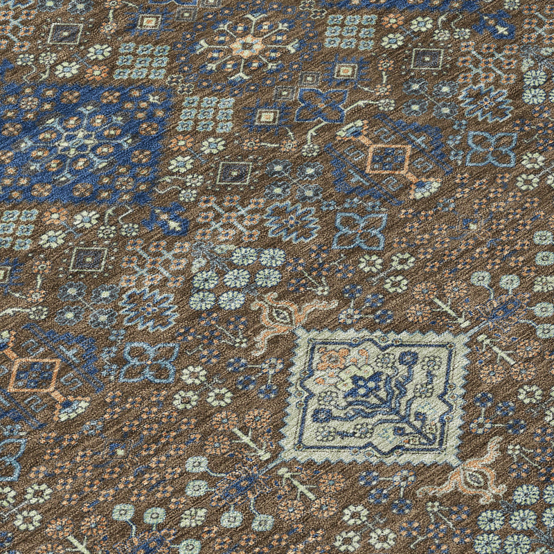 Close-up of geometric area rug pattern with brown, blue, and cream motifs
