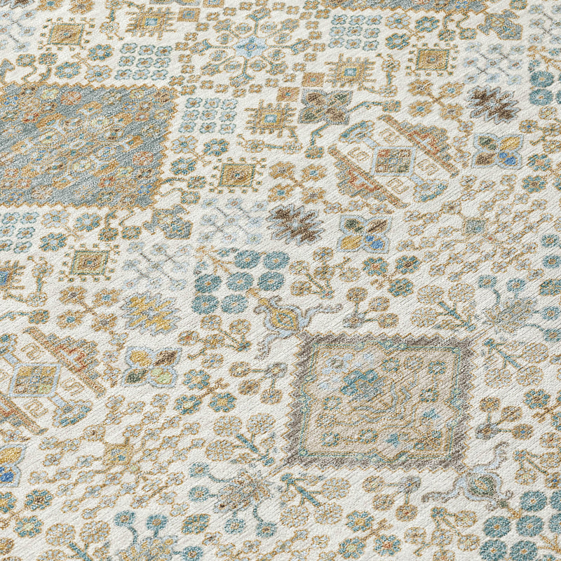 Close-up of round rug pattern with ivory, teal, and copper geometric motifs