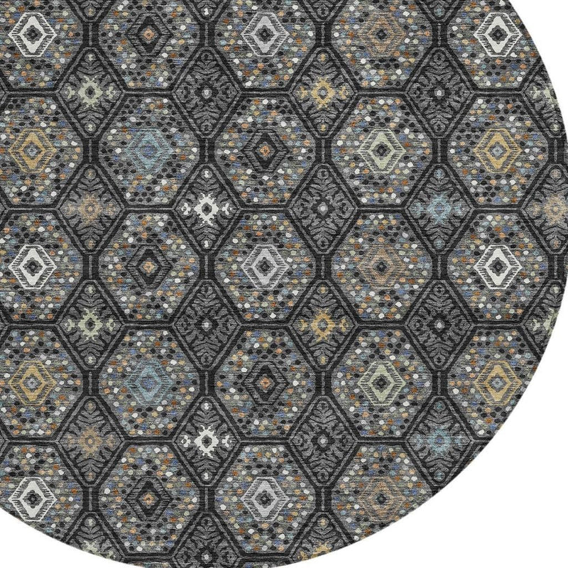 Round area rug close-up: dark charcoal hex tiles with white and light gray diamond motifs