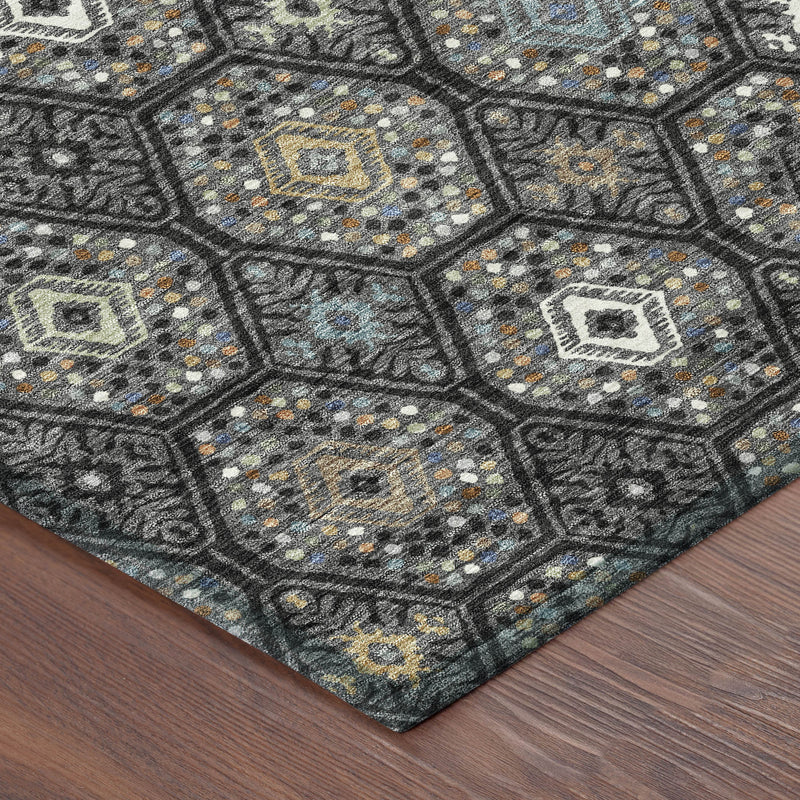 Round area rug with dark charcoal geometric pattern, bound edge visible at the corner