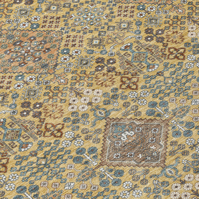 Close-up of round area rug geometric pattern in gold, copper, and blue