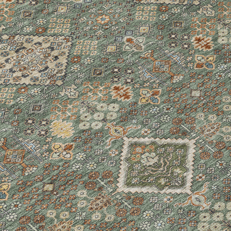 Close-up geometric area rug with teal-green background and taupe cream diamond motifs