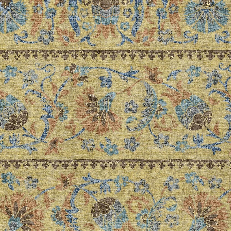 Close-up of gold, teal, and brown distressed floral rug with patterned border detail