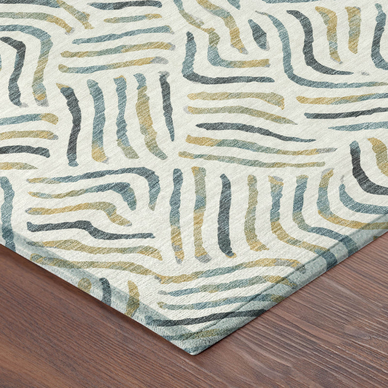Corner of ivory abstract rug with blue and gold wavy lines and flat edge