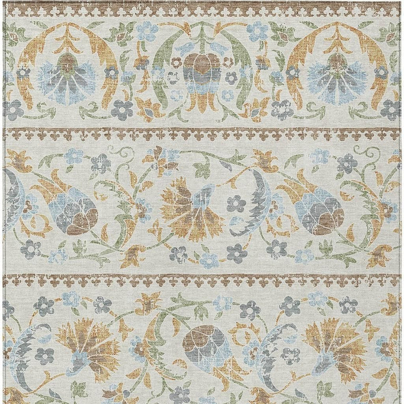 Ivory area rug with ornate floral border medallions in blue, green, and tan