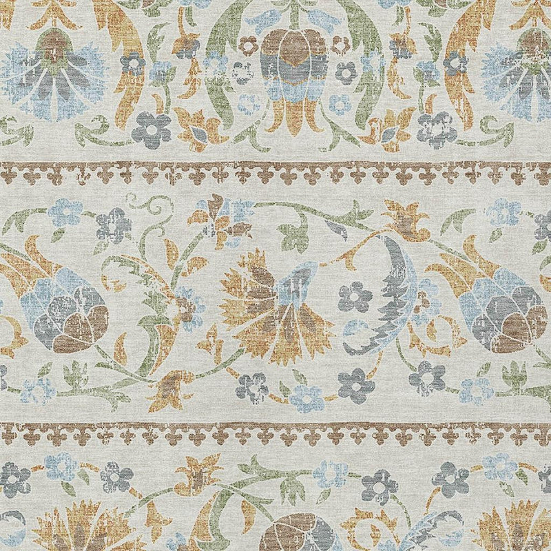 Ivory floral pattern area rug with blue, green, and tan scrollwork and borders
