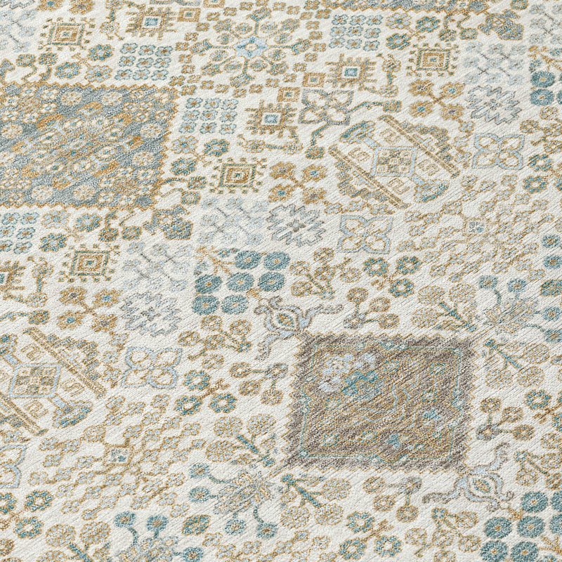 Round rug close-up of ivory and teal geometric motif with copper details