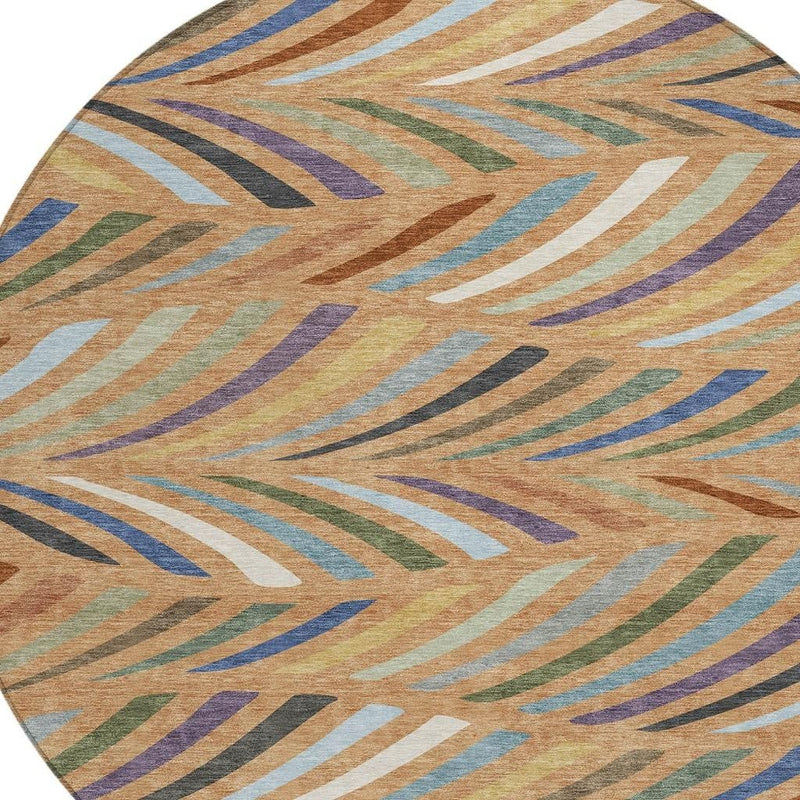 Close-up of round area rug with multicolor abstract stripe pattern in tan and blue
