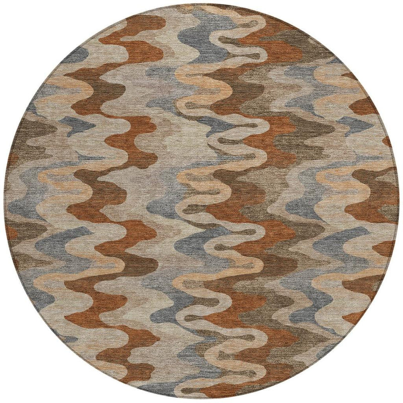 Round area rug with abstract camouflage-style zigzag pattern in brown, gray, and cream