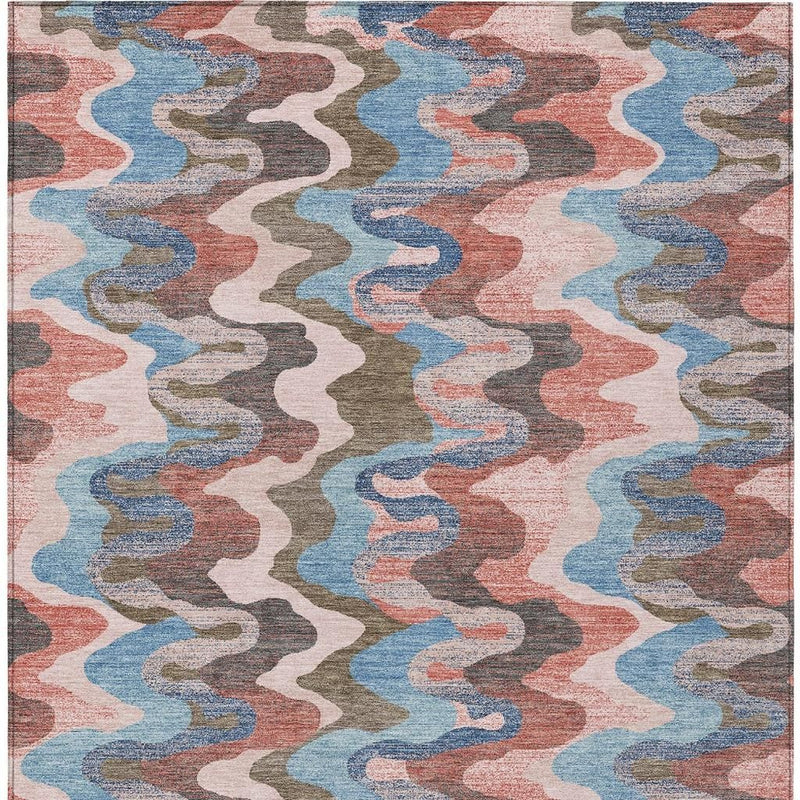 Multicolor abstract zigzag area rug with pink, coral, blue, and gray wavy lines.