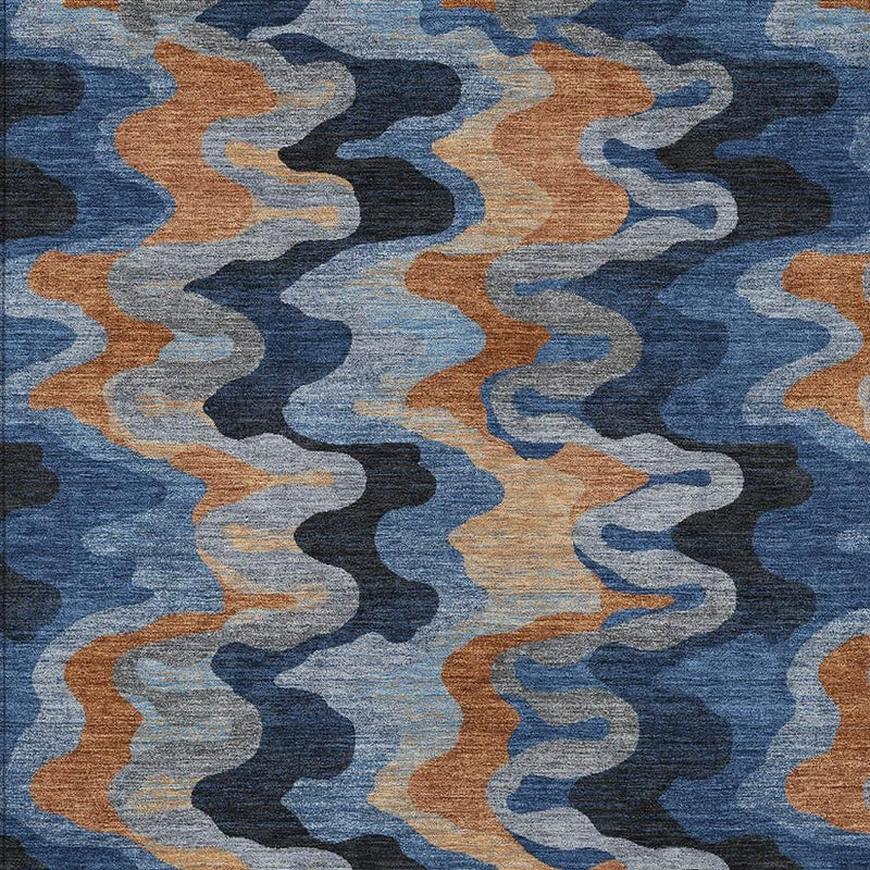 Navy and black abstract zigzag rug close-up with tan and light blue waves