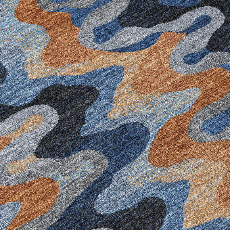 Close-up of abstract rug surface with navy, brown, tan, and light blue zigzags