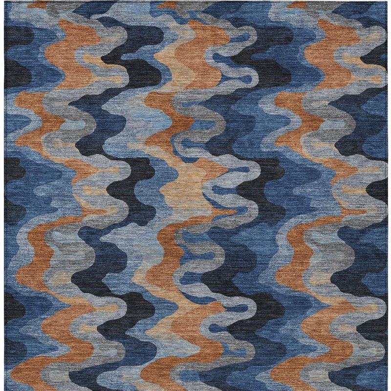 Abstract indoor/outdoor area rug with repeating navy, tan, and light blue zigzag pattern