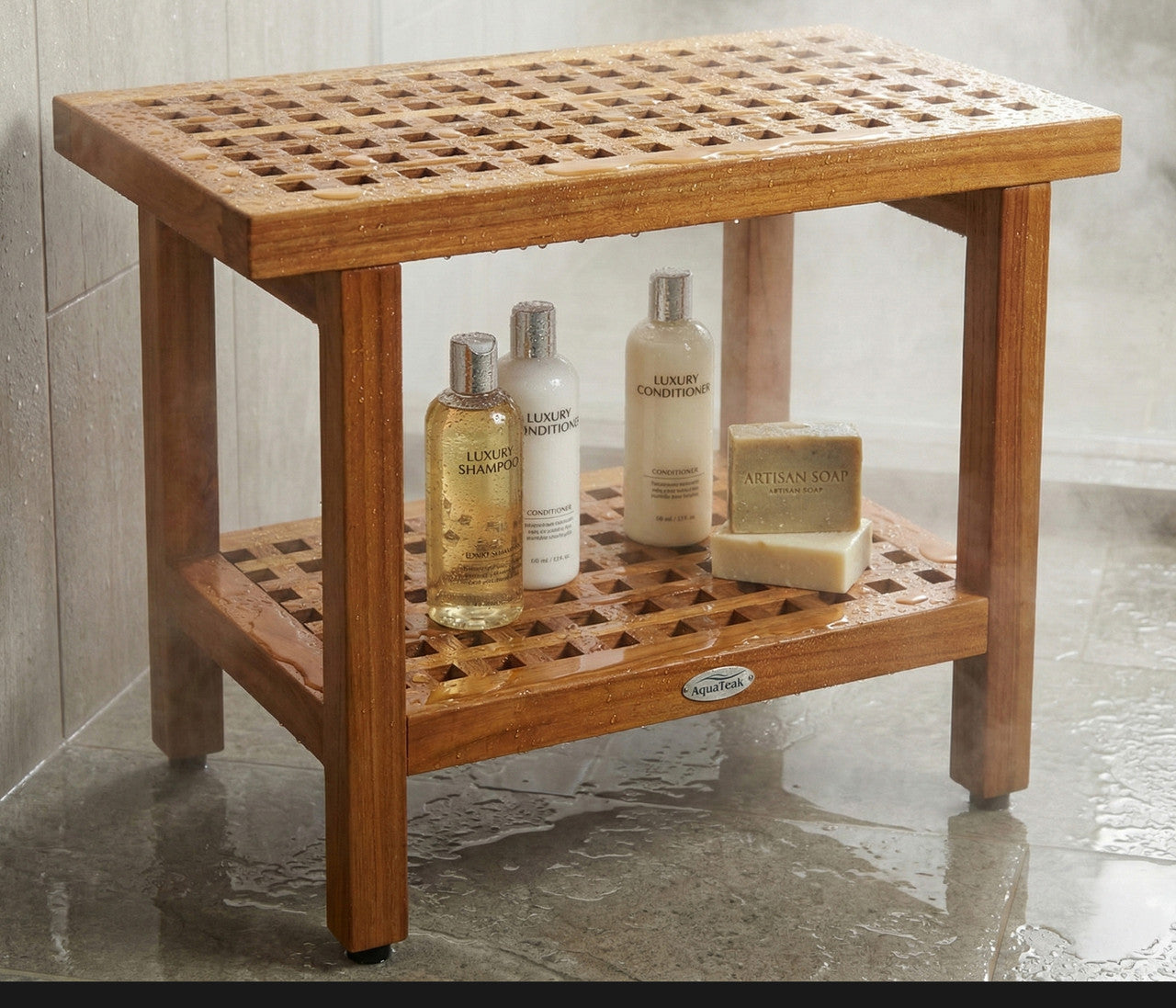 Brown teak shower bench with slatted top, lower shelf, and bath items on shelf