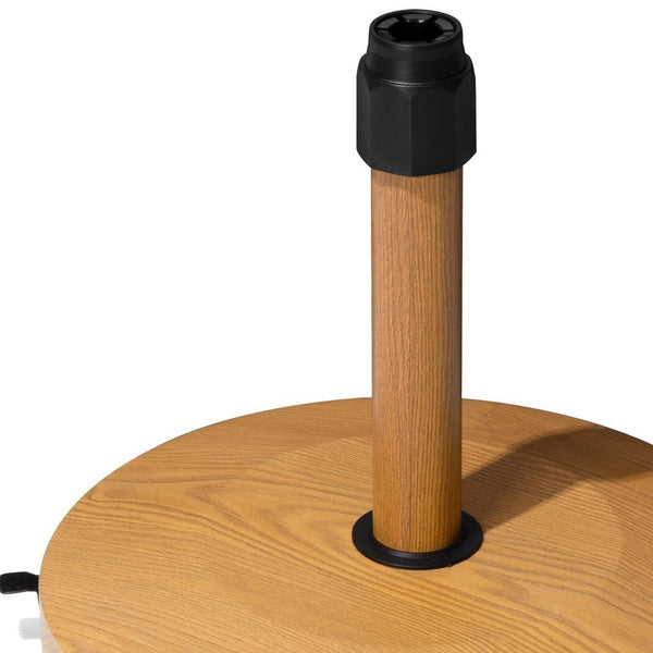 Light brown market umbrella base with wood pole and black ground stake cap