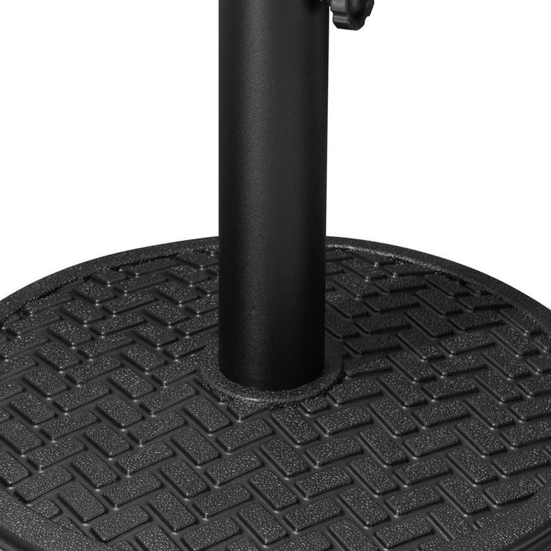 Black umbrella base texture with upright pole set in center of round plate