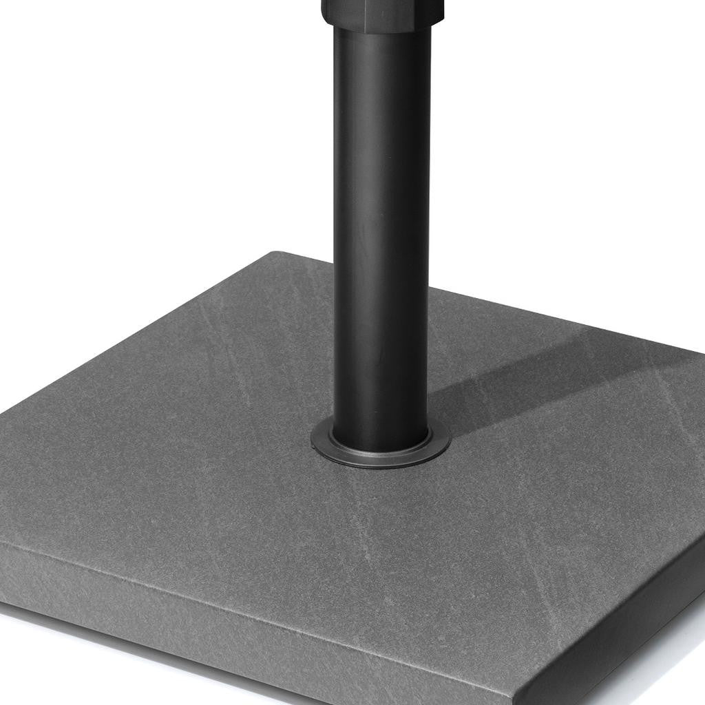 Gray in-ground umbrella base with central black steel pole and round mounting plate