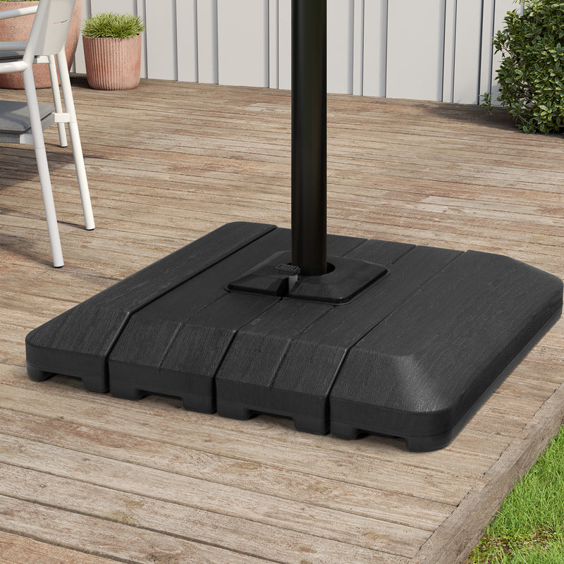 Black in-ground umbrella base with cantilever pole set upright on patio deck