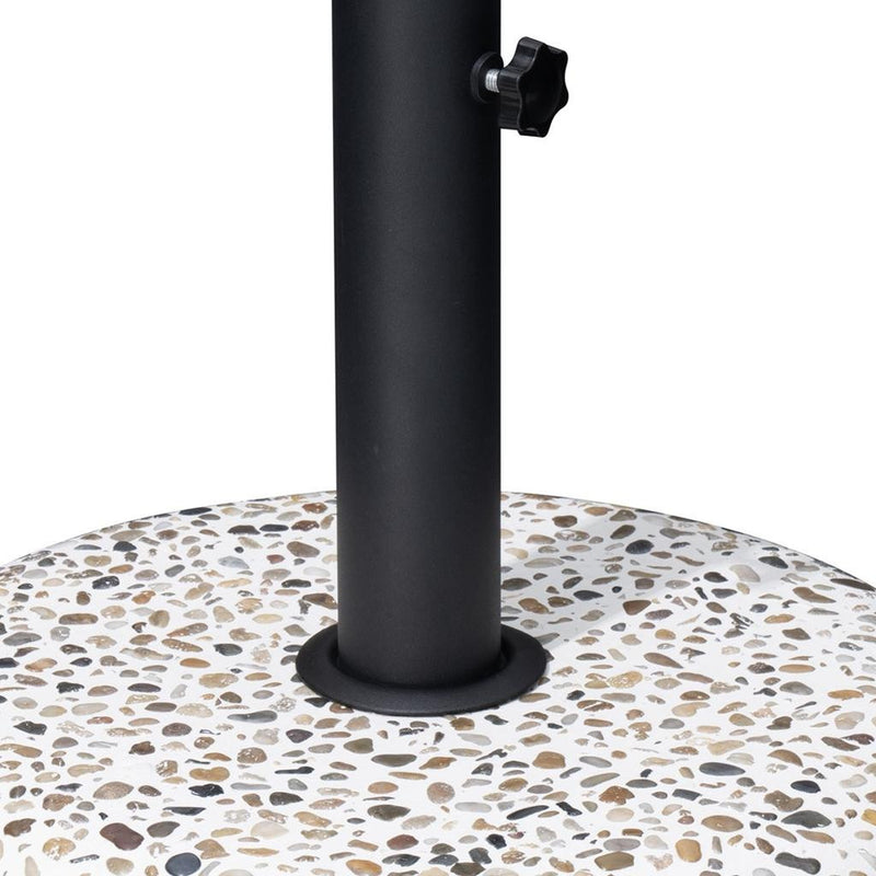 Black steel umbrella base post anchored on speckled stone mosaic round weight
