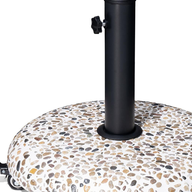 Black umbrella pole mounted on a speckled stone-pattern round base