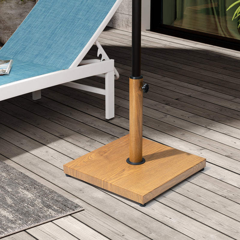 Wood-toned in-ground umbrella base with tall pole and black base ring on deck