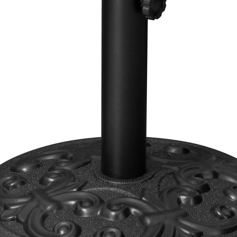 Black umbrella base top view showing textured plate and vertical pole