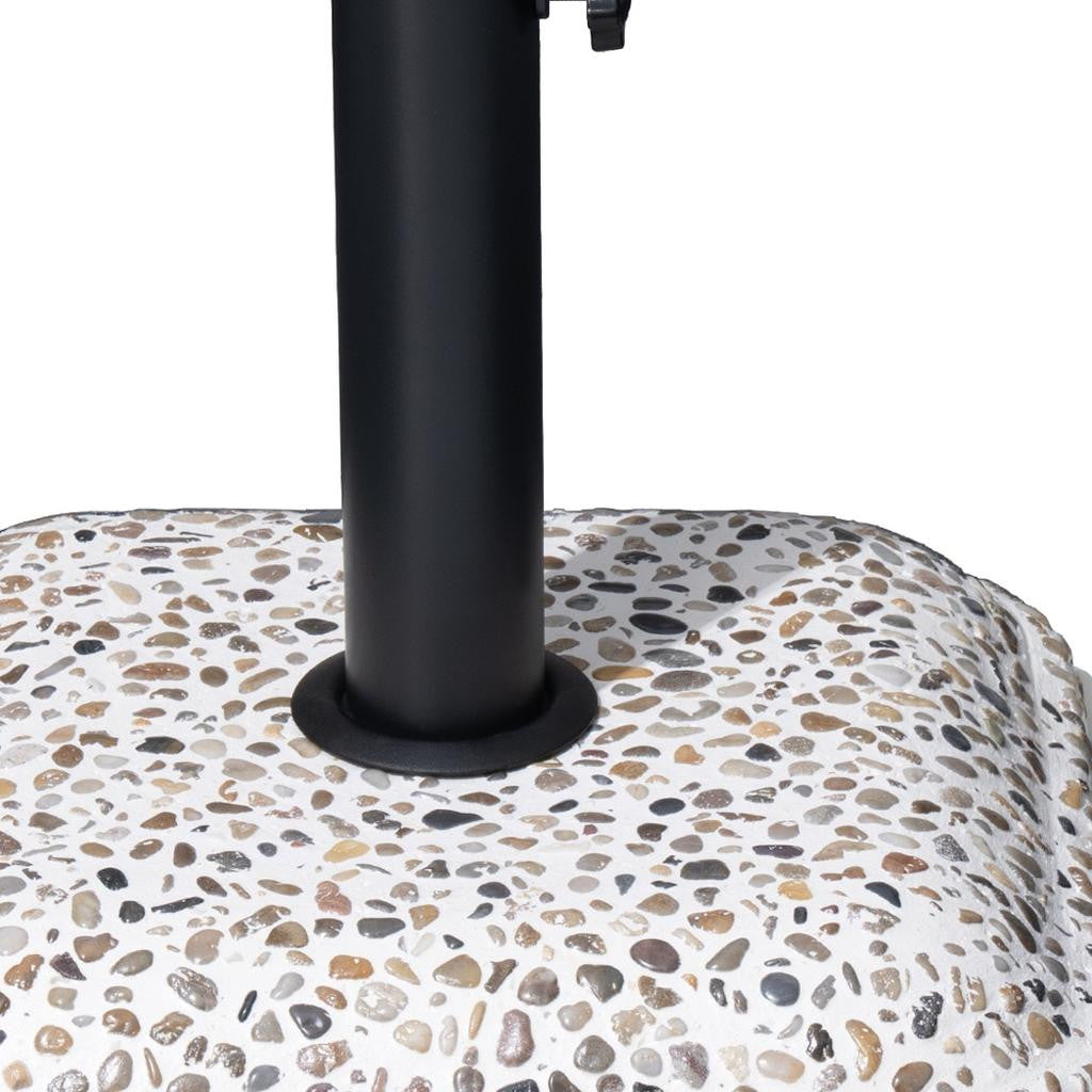 Close-up of black steel umbrella pole base on speckled stone-pattern slab