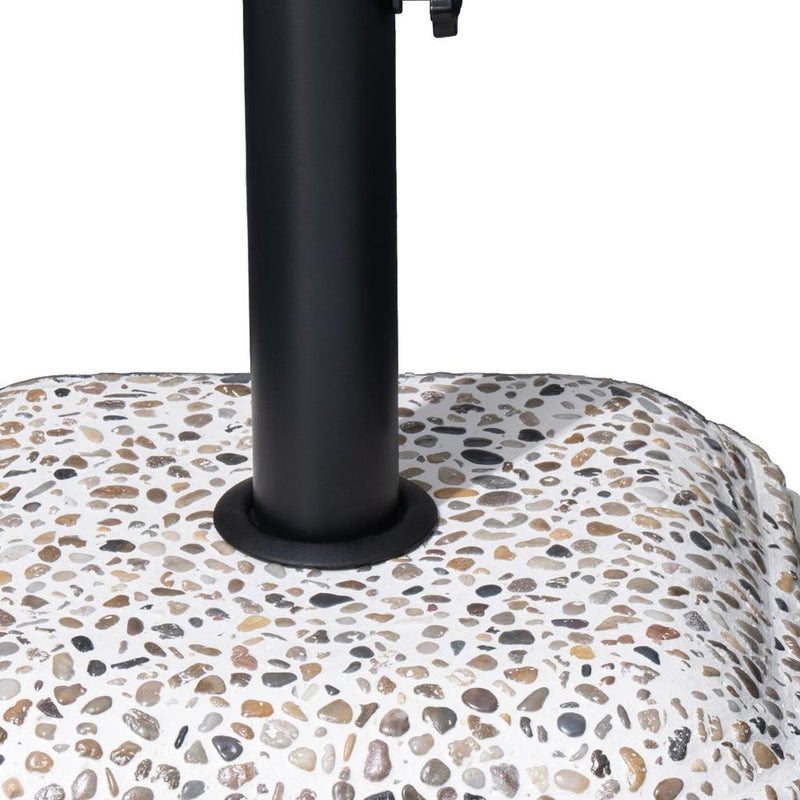 Close-up of black steel umbrella pole base on speckled stone-pattern slab