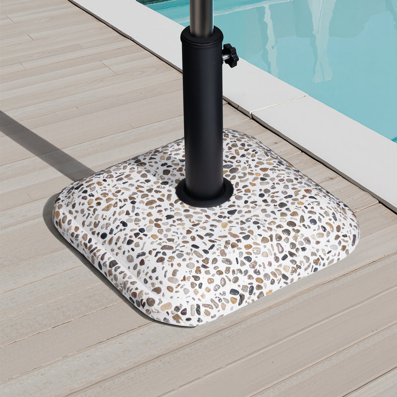 Stone-pattern in-ground umbrella base with black steel pole on patio surface