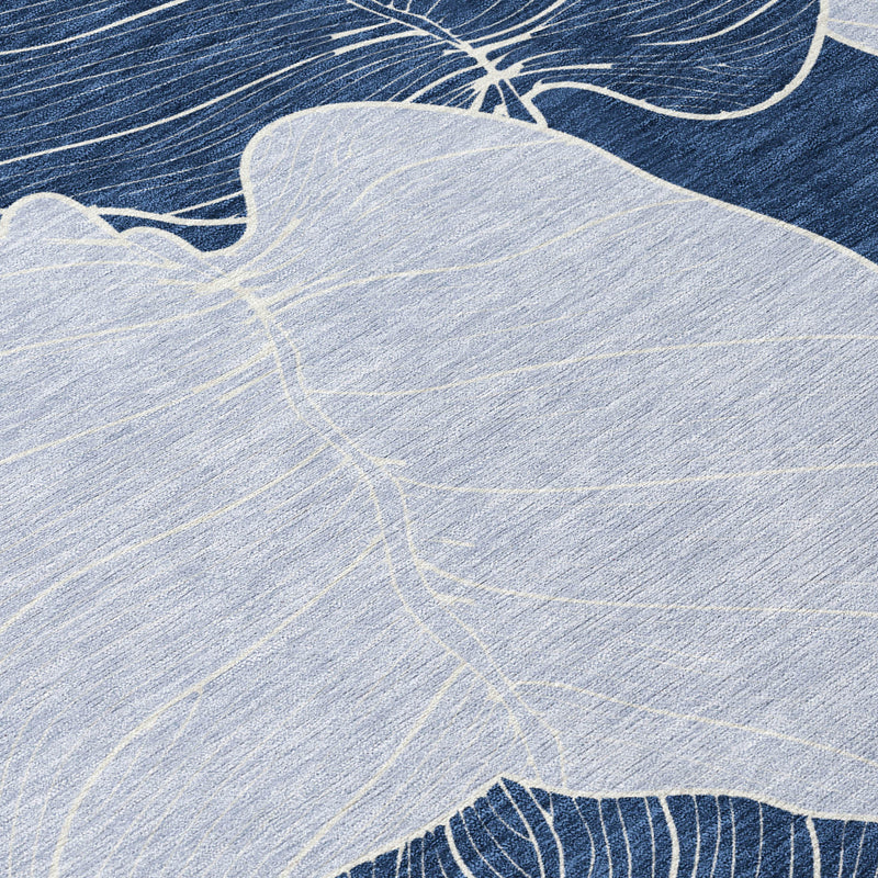 Navy and ivory leaf design area rug, close-up view of stitched vein lines.