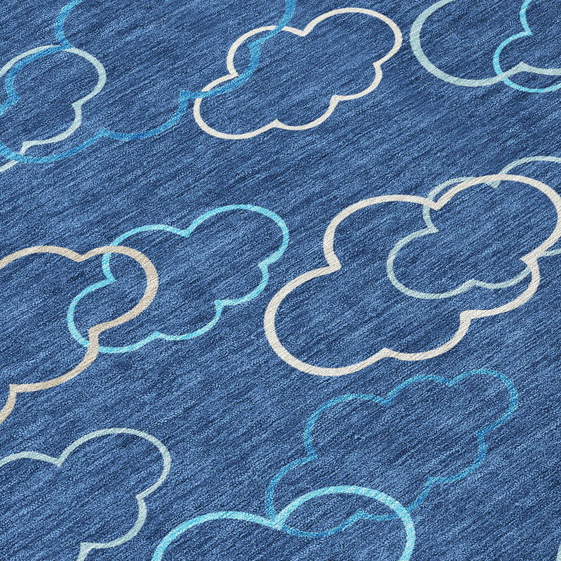 Navy abstract area rug with light ivory and teal cloud outlines, close-up