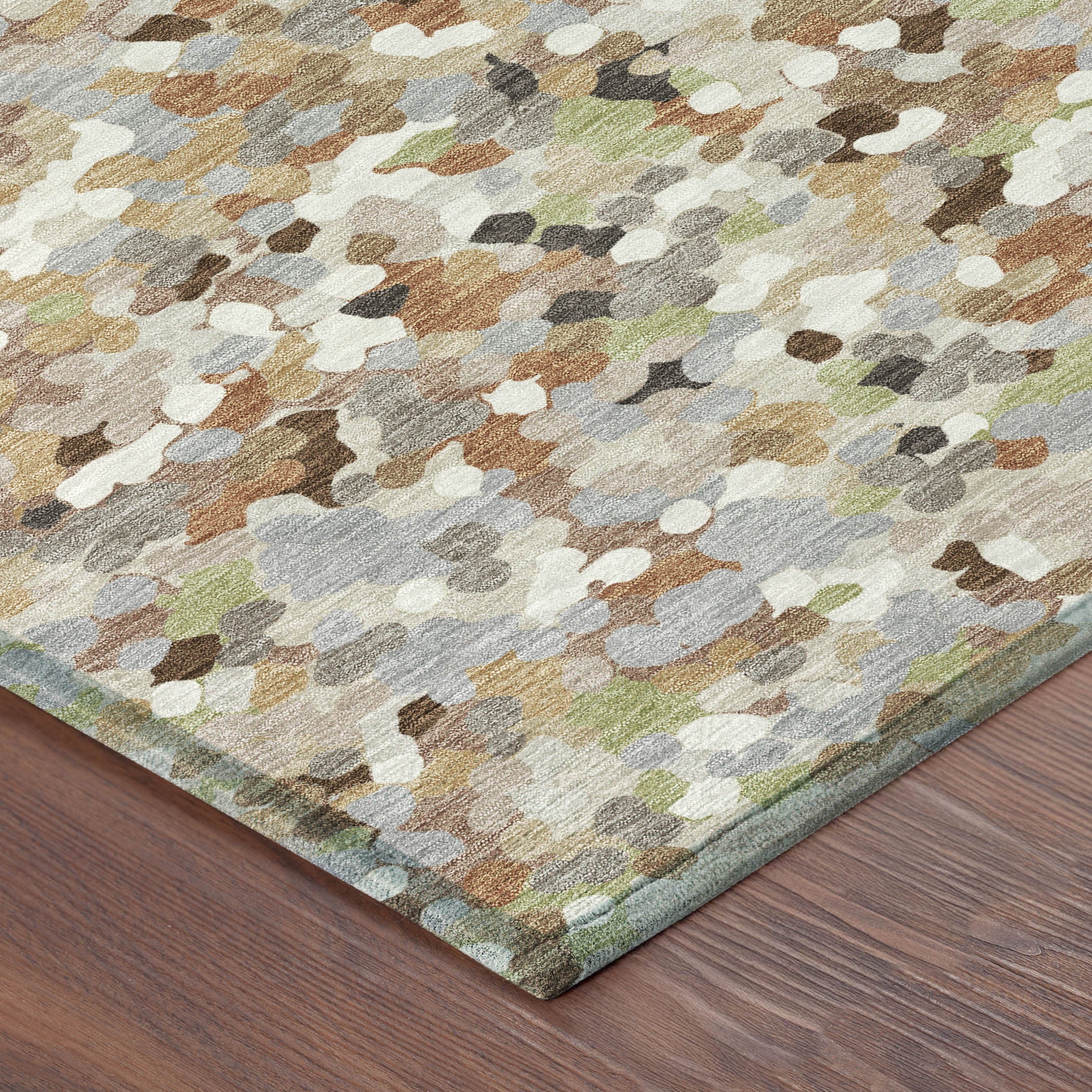 Beige and gray geometric area rug with multicolor speckled pattern, corner view