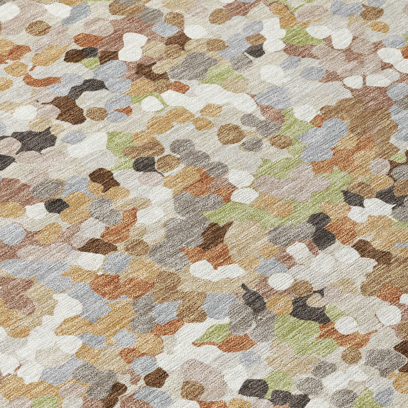 Geometric area rug close-up with multicolor speckled motif in beige and gray