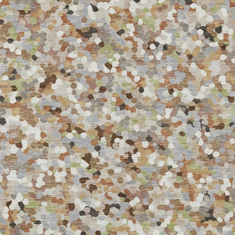 Geometric area rug close-up, dense speckled pattern in beige, gray, and muted colors
