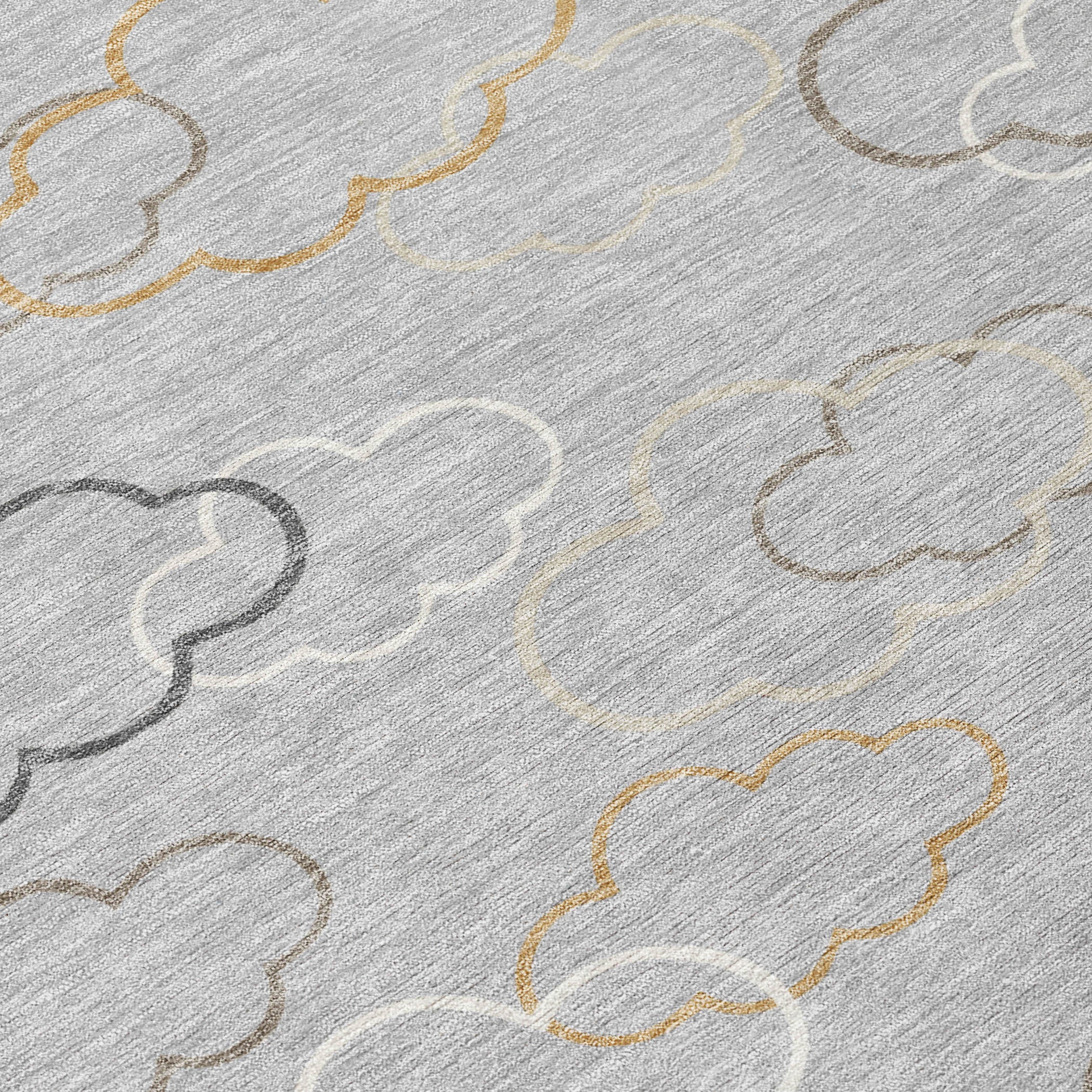 Silver rug close-up with cloud outlines and beige/gold accents on textured pile