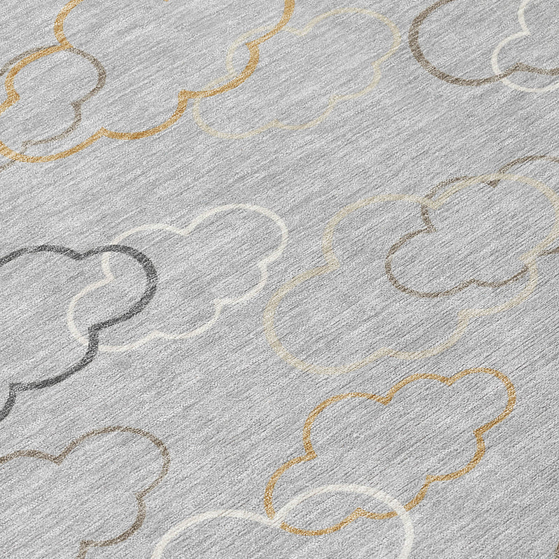 Silver rug close-up with cloud outlines and beige/gold accents on textured pile