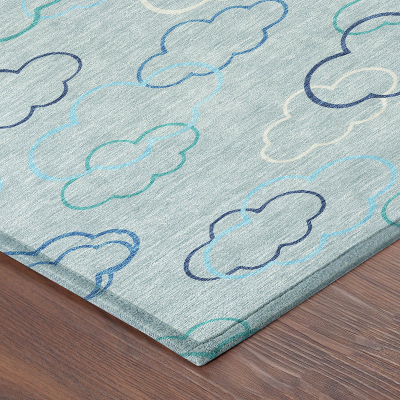 Sky blue area rug corner detail with cloud outline pattern in navy and teal