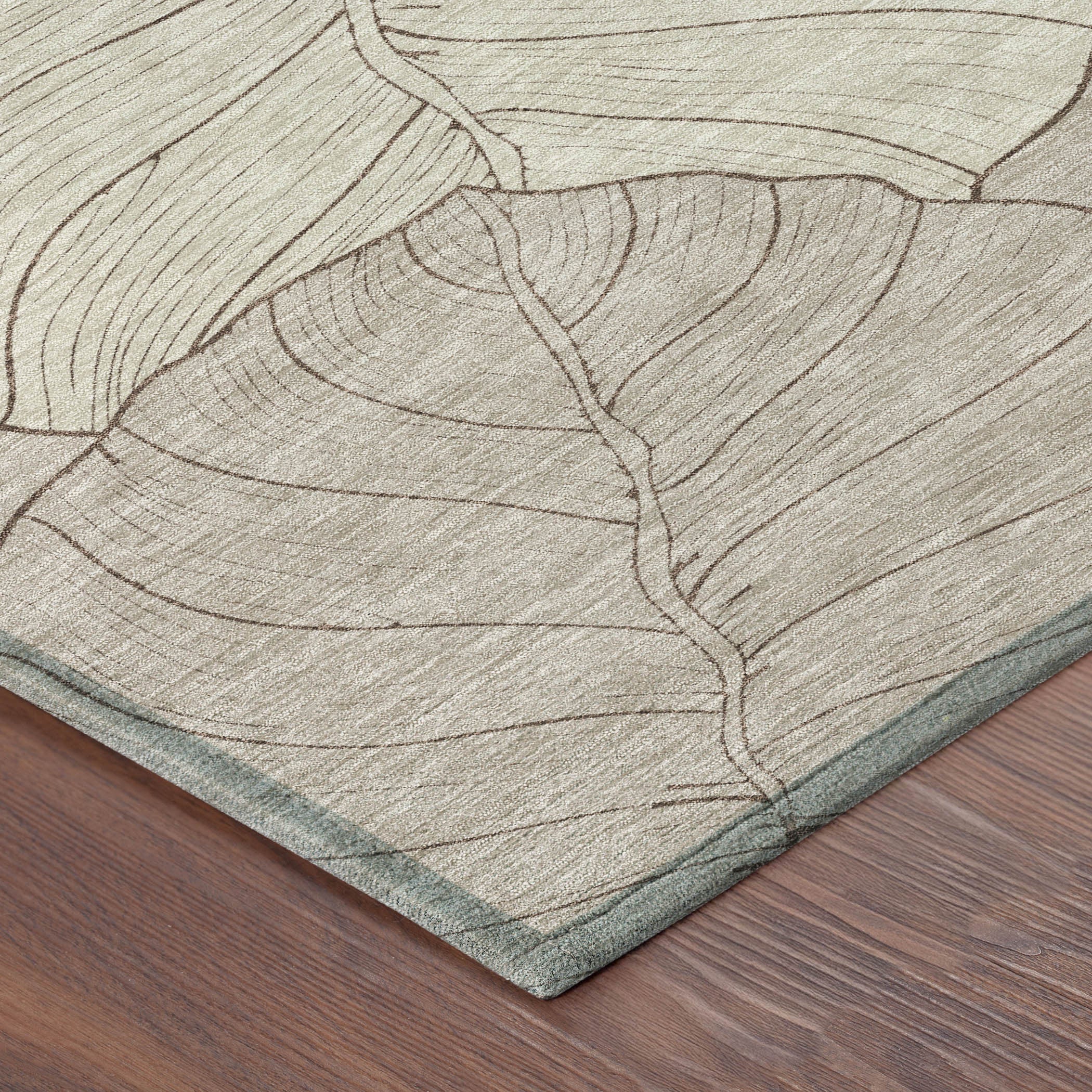 Taupe and beige leaf floral area rug corner with light teal backing