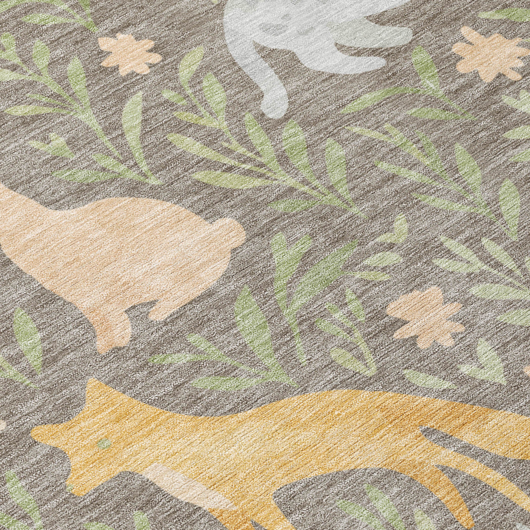 Round rug pattern detail with green foliage, tan animal shapes, and gray fabric base
